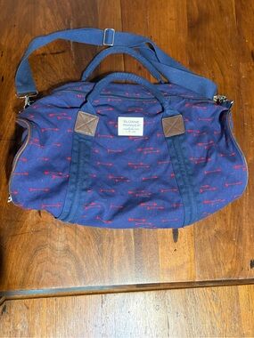 Used Sloan Ranger navy and red arrow canvas duffel bag